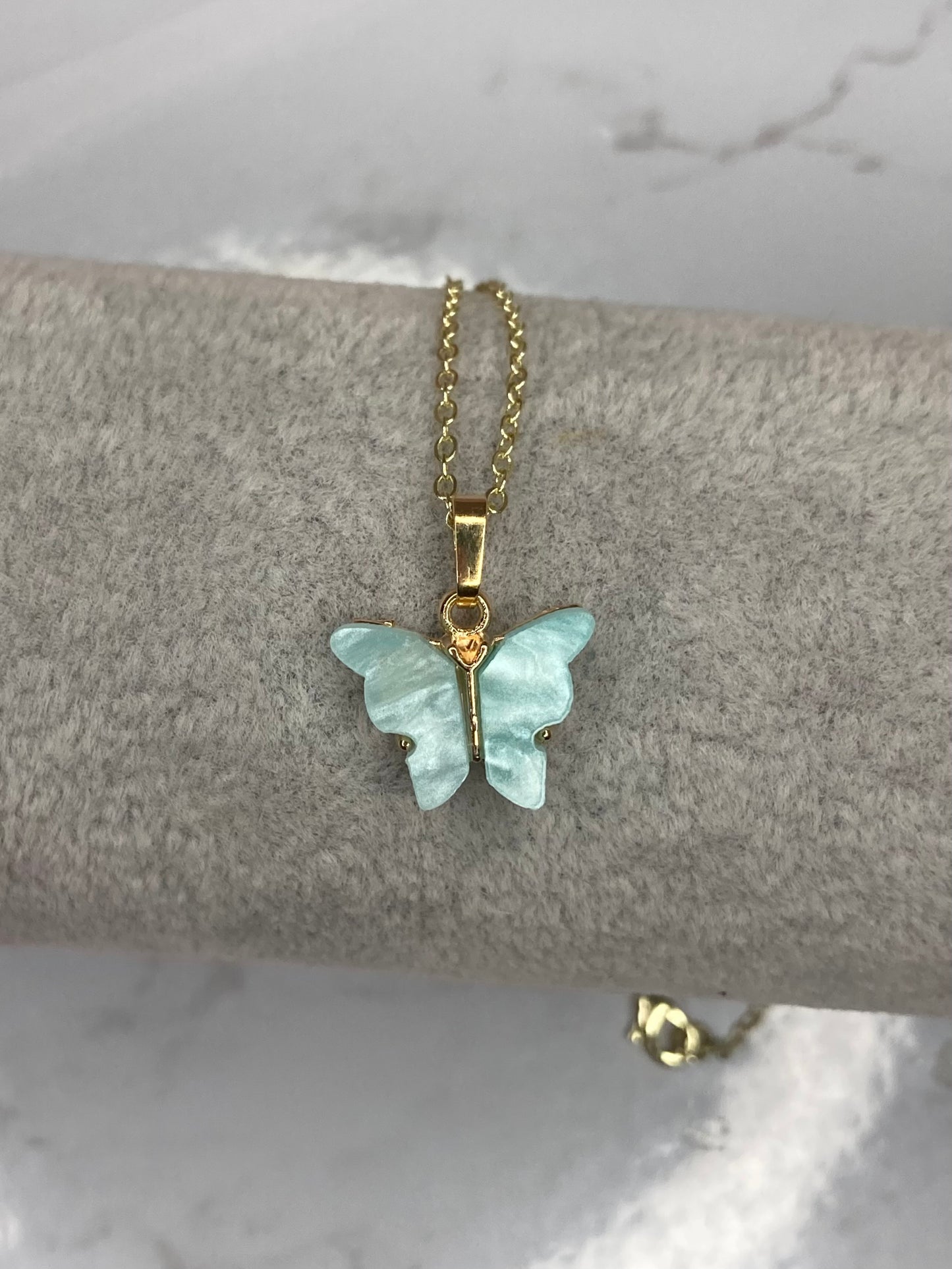 Teal fluttering butterfly necklace